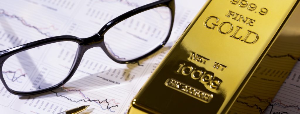 How to Invest in Gold - image of Gold Bar on Newspaper