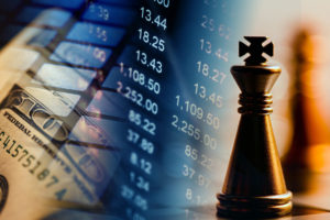 Dividend Kings - a chess king piece in front of a stock ticker and $100 bills
