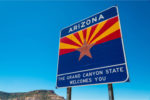 Arizona Wins Major Flat Tax Victory Arizona state border highway sign with a sky blue background