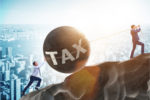 Work Hard in NY and CA? Prepare to PAY Under Democrats’ New Tax Plan Two men in business suits struggling to roll a giant stone ball labeled "tax" up a steep hill.